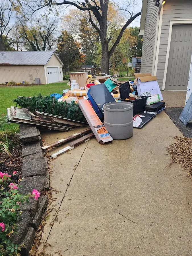 Dumpster being loaded with debris for Roofing Dumpster Rental in Anchorage